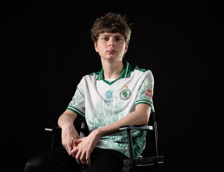 Team Falcons CS2 player kyousuke sitting on a chair while looking fiercely at the camera on a black background.