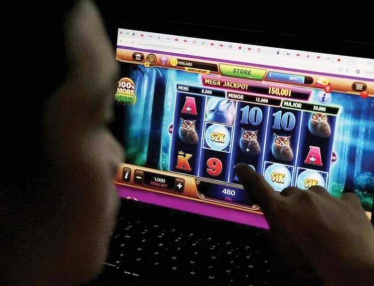 A Filipino playing an online casino game on a laptop.