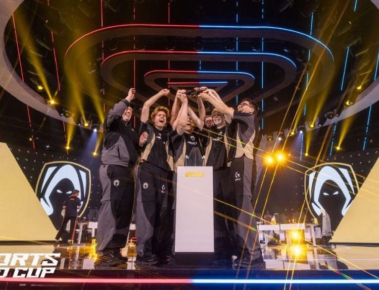 an image of Team Heretics players lifting the VALORANT trophy at EWC 2025