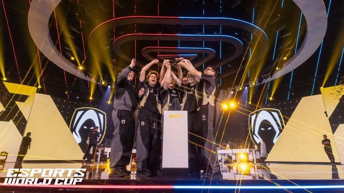 an image of Team Heretics players lifting the VALORANT trophy at EWC 2025