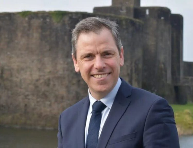 Chris Evans MP portrait against a castle.