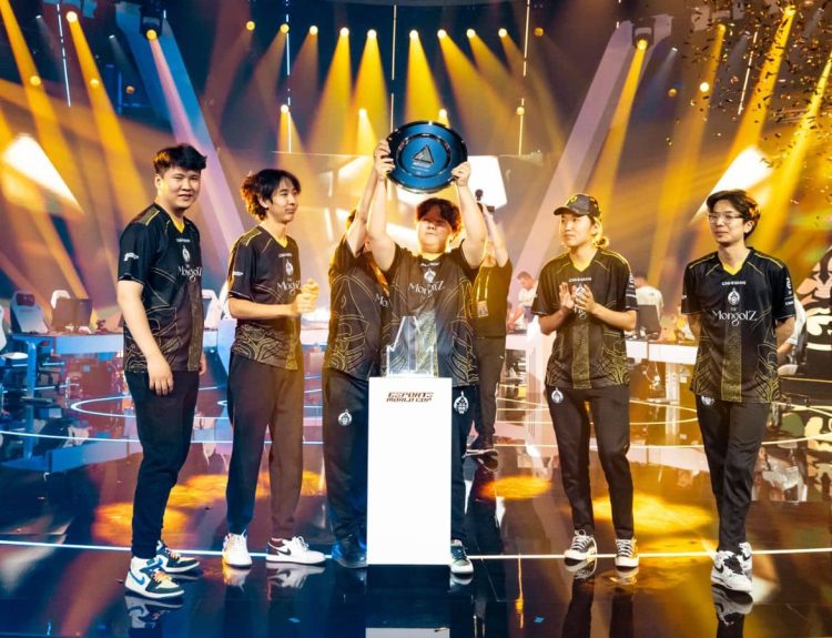 Mzinho lifts the trophy as The Mongolz celebrate their victory at EWC 2025 CS2 tournament.