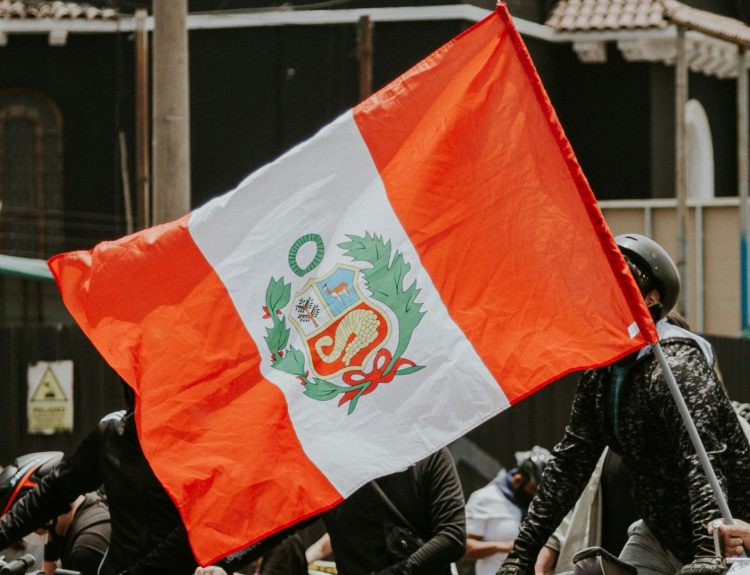Peru state flag carried by bicycle riders.