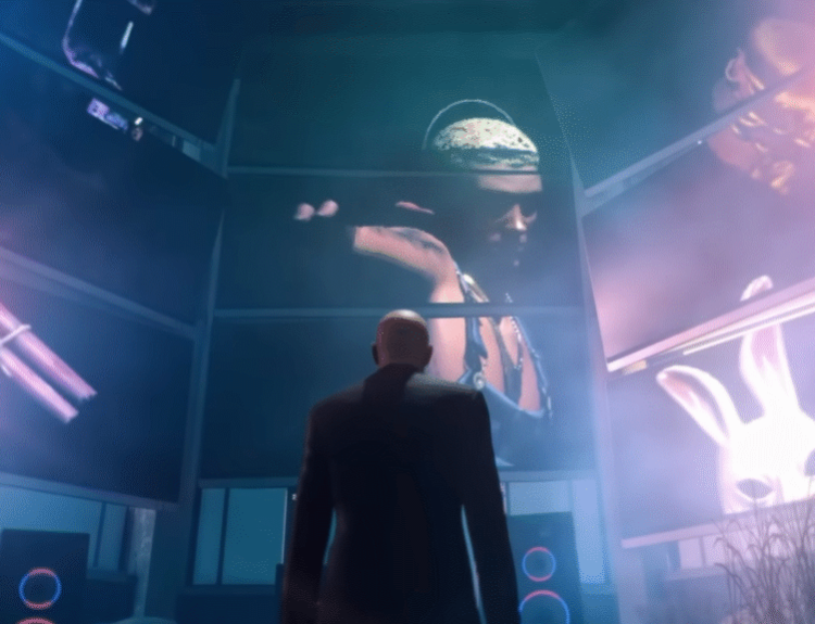 HITMAN Agent 47 stands in front of large display of Slim Shady